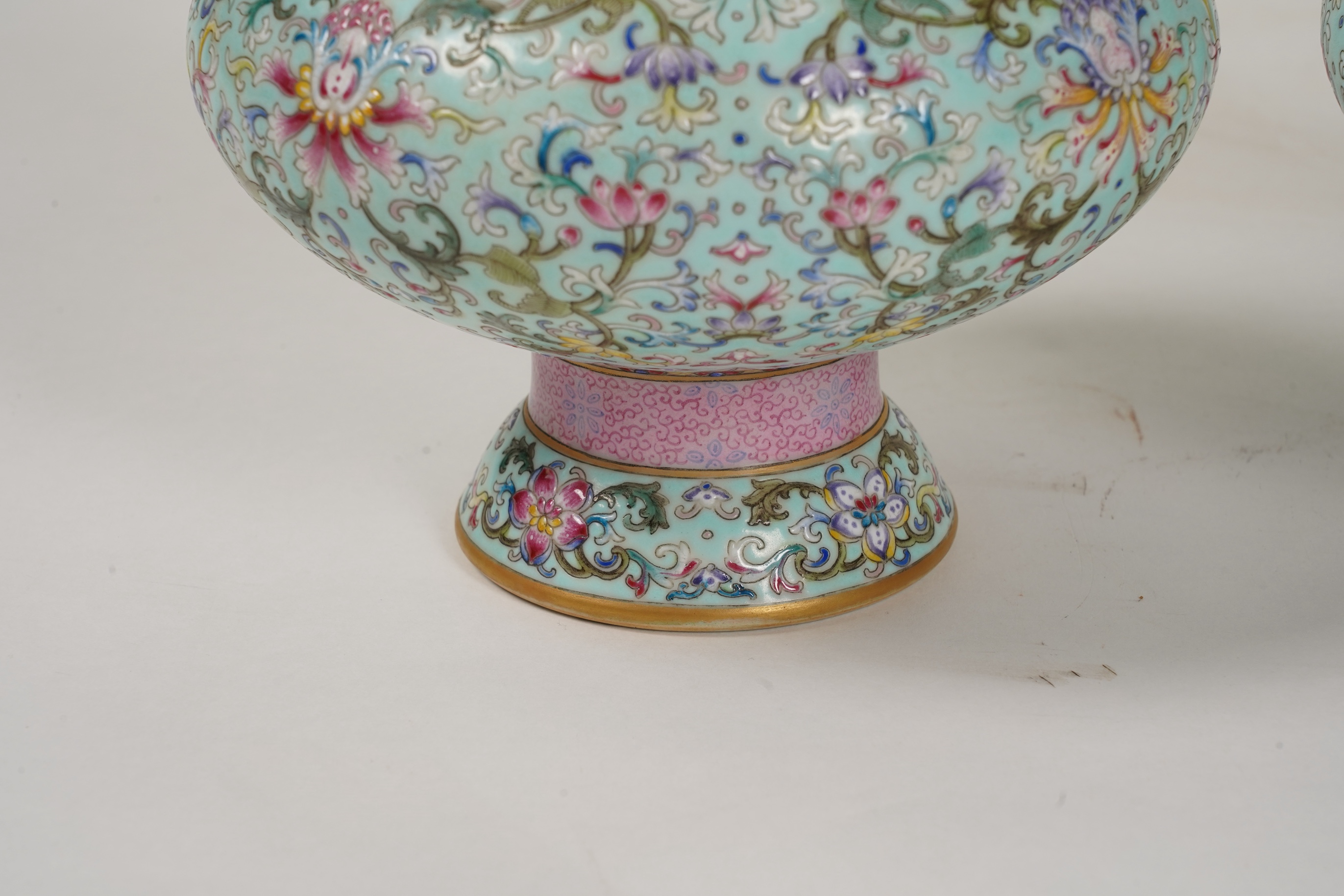 A pair of Chinese famille rose enamelled porcelain bottle vases, Qianlong seal mark to base but Republic Period